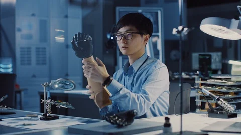 Futuristic Prosthetic Robot Arm Being Tested by Professional Japanese Developer Stock Footage 105343664