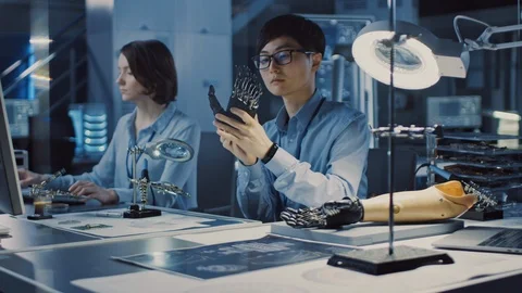Futuristic Prosthetic Robot Arm Being Tested by Professional Japanese Developer Stock Footage 105344212