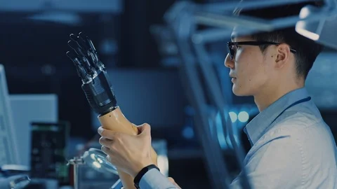 Futuristic Prosthetic Robot Arm Being Tested by a Professional Japanese Engineer Stock Footage 105353946