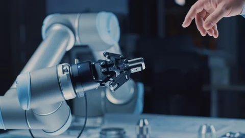 Futuristic Robot Arm Touches Human Hand in Humanity and Artificial Intelligence Stock Footage