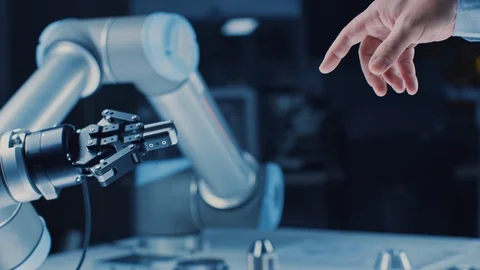 Futuristic Robot Arm Touches Human Hand in Humanity and Artificial Intelligence Stock Footage 105366968