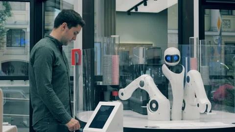 Futuristic robot arm works serving man. Man placing his coffee order in a robot Video stock 140636216