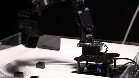 Futuristic robot carrying black block Stock Footage 99051743