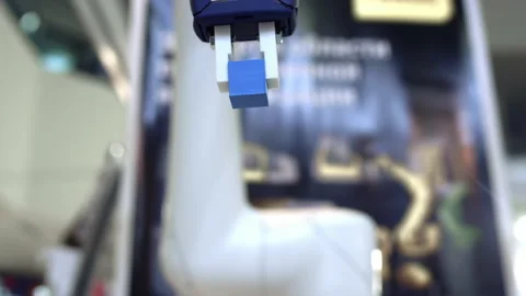 Futuristic robot hand picks up and moves colored cubes, artificial intelligence Stock Footage 142793832