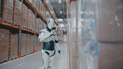 Futuristic robot scanning barcode on stacked boxes with handheld reader inside Stock Footage 314392801