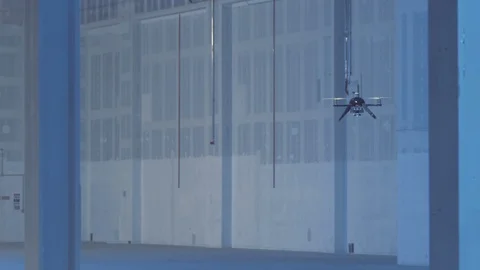 Futuristic sci-fi delivery drone flies inside giant warehouse - slow motion Stock Footage 106711348
