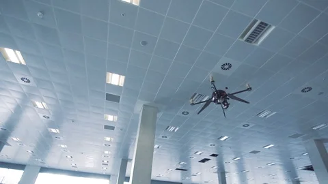 Futuristic sci-fi drone flies and scans huge empty office - camera tracks past Stock Footage 106395704