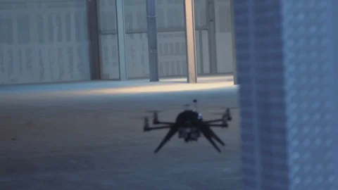 Futuristic sci-fi drone flies past while inspecting warehouse v3 handheld Stock Footage 106710879