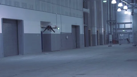 Futuristic sci-fi drone flies past while inspecting warehouse v4 Stock Footage 106710932