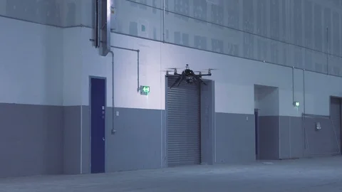 Futuristic sci-fi drone flies past while inspecting warehouse v5 Stock Footage 106710942