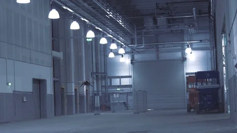 Futuristic sci-fi drone flies past while inspecting warehouse v6 Stock Footage 106710968