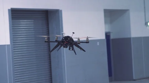 Futuristic sci-fi drone flies past while inspecting warehouse v8 Stock Footage 106711017