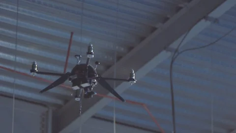 Futuristic sci-fi drone hovers inside huge industrial building Stock Footage 106711667