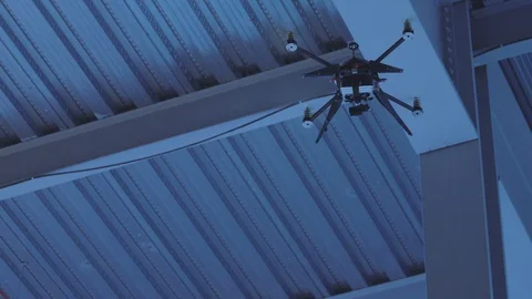 Futuristic sci-fi drone hovers high inside industrial factory Stock Footage 106711756