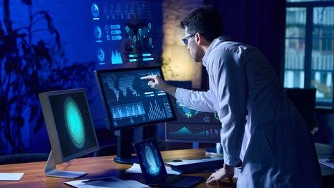 Futuristic scientist standing at interactive holographic dashboard analyzing AI 库存照片