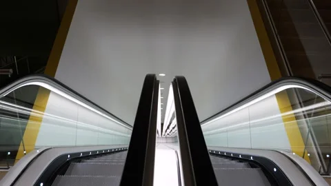 Futuristic shot of empty, neon-lit escalator looking down. Stock Footage 259203081