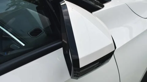 Futuristic side mirror smoothly unfolds on modern car, emphasizing advanced Stock Footage 311231569