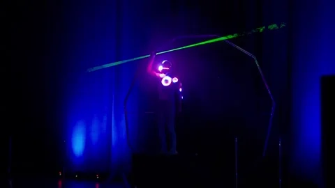 Futuristic spaceman performer during laser show on stage Video stock 328400304