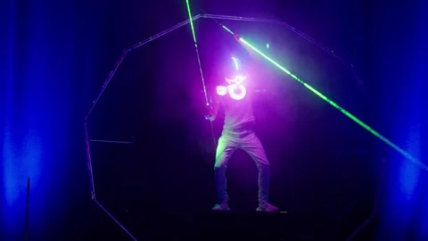 Futuristic spaceman performer during laser show on stage Video stock 328400369