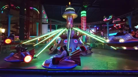 Futuristic Spaceship Carousel Ride Spinning in Indoor Theme Park Stock Footage 342219628