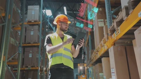 Futuristic technology in the warehouse. A man with a tablet in a warehouse Vidéo 221773159