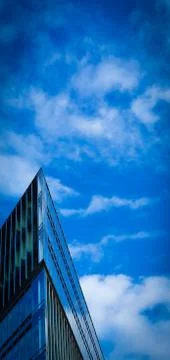 Futuristic triangular building against a clear blue sky 스톡 사진