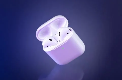 Futuristic wireless earbuds on blue 写真素材
