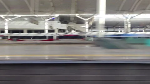 Fuxing bullet train running past a railway station in China Stock Footage 293666939