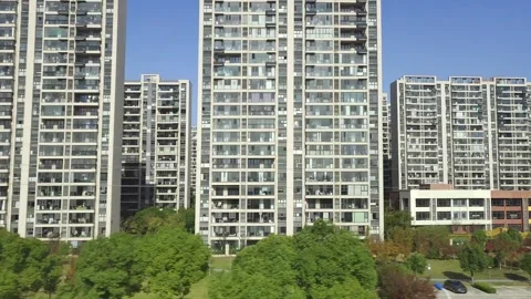 Fuxing bullet train running past apartment buildings in China Stock Footage 293667302