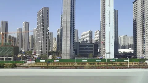 Fuxing bullet train running past apartment buildings in China Stock Footage 293667305