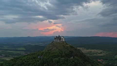 Füzér Castle in Hungary beneath storm clouds at dusk in drone hyperlapse Stock Footage 340106812