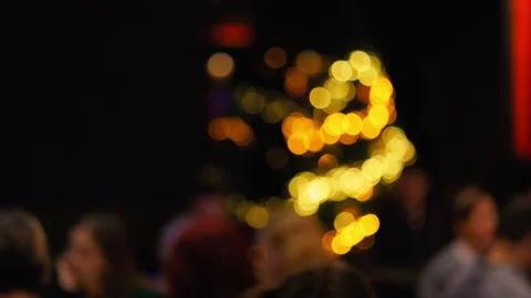Fuzzy festive scene, Blurry audience observing colorful holiday illumination Stock-Footage 325349360