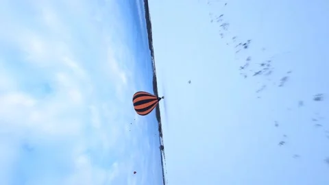 FV Vertical 4k Aerial View of Hot Air Balloon Parachute and Basket in Snow Stock Footage 195454596