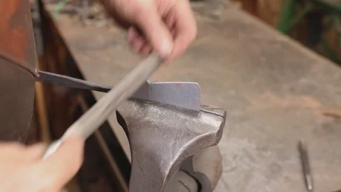 Fviling work held in blacksmiths vise Stock Footage 160302011