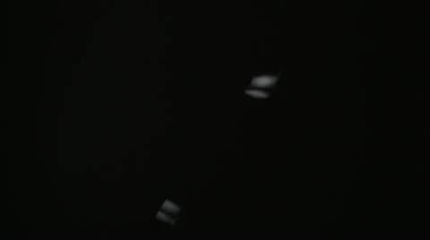 FX Light Confetti Falling Against Black Background Vídeo Stock 12635710