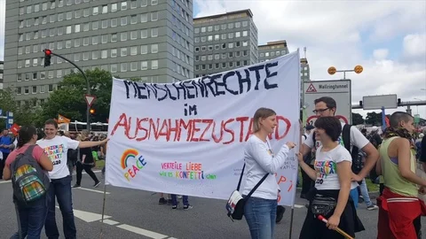 G20 demonstration Hamburg 2017, two demonstrators hold banner for human rights Video stock 77556426