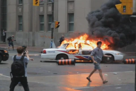 G20 Toronto. Burning police car explosions wide. SD. Stock Footage