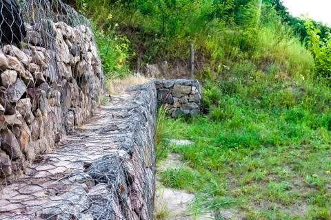 Gabion wall - stones in wire mesh used for erosion control Stock Photos