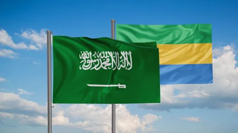 Gabon flag and Saudi Arabia flag waving together on blue sky, looped video, two Stock Footage 244063053