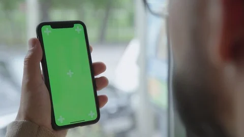 Gadget, screen with a green screen. Man holds the phone with one hand. Stock Footage 93561539