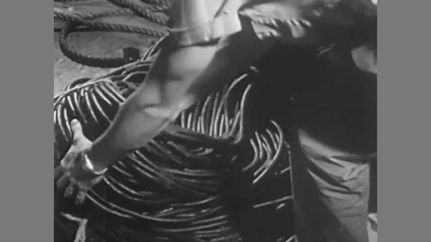 A gaffer connects cables to an electric panel on for a theatre play in the Stock Footage 88678440