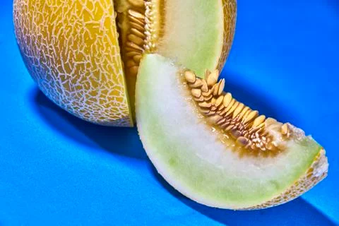 Gaia melon slice on blue background Photos