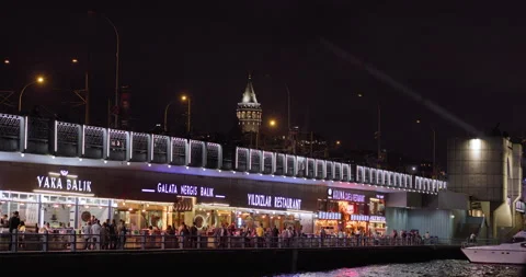 Galata Bridge with Galata Tower in the background, in Istanbul, at night Stock Footage 220886946