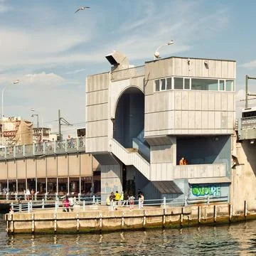 Galata Bridge spans Bosphorus Strait with pedestrians, and fish restaurants Stock Photos