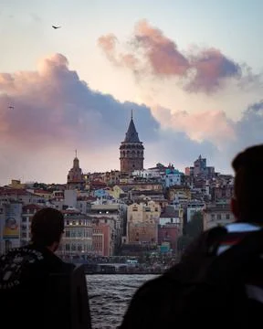 Galata Tower seen between a crowd of people in Istanbul Stock Photos