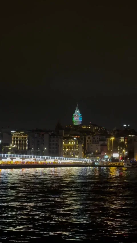 Galata Tower view from ferry at night. Visit Istanbul vertical footage Stock Footage 297863598