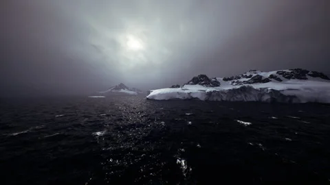 Gale force winds batter icy coastlines beneath ominous clouds Stock Footage 342922386