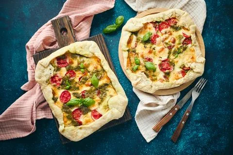 Galette-type pie made from puff pastry and filled with tomatoes, mozzarella.. Stock Photos