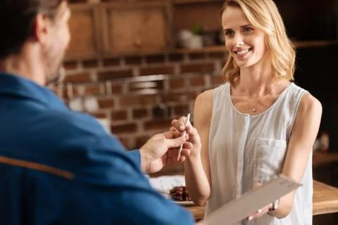 Gallant nice guy giving pen to the lady Stock Photos