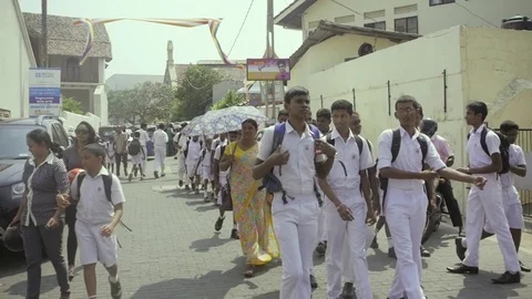 Galle, SRI LANKA - JANUARY 25: School children and a buddhist monk on a school Stock Footage